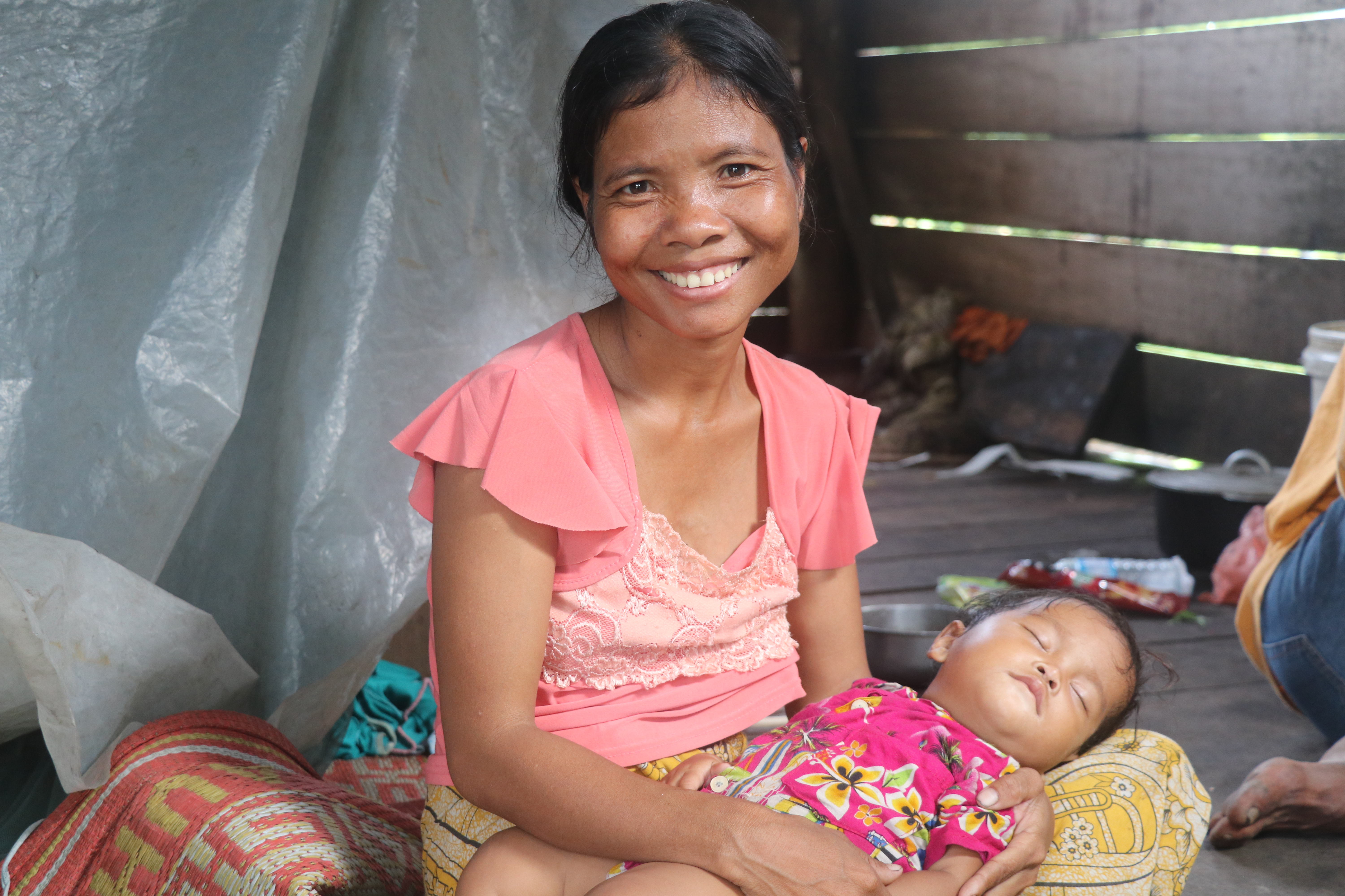 Bora putting her fifth kid to sleep at her stilt-wooden hut in Kantuot Village, Choam Ksan district, Preah Vihear province